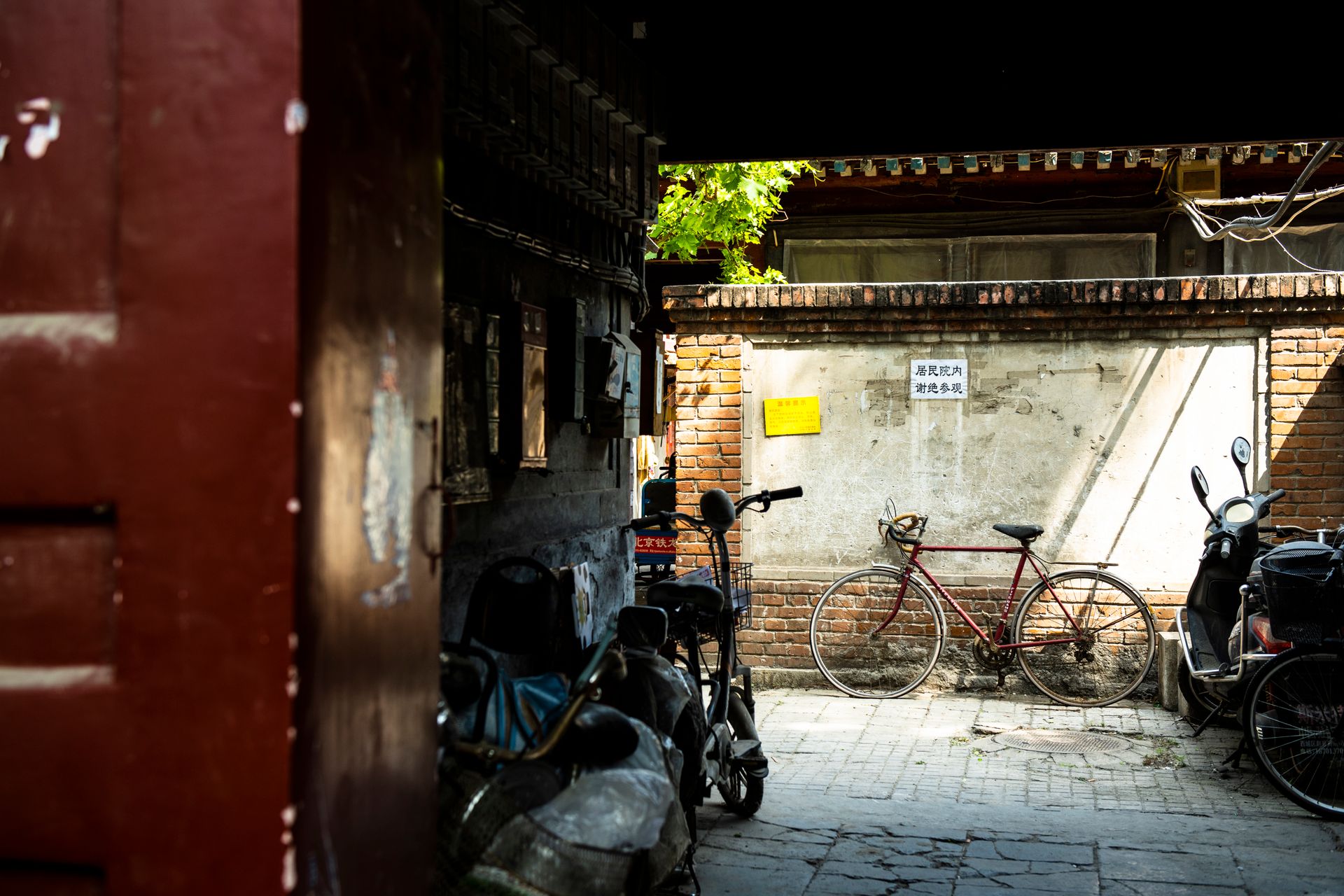 Cyclist riding through a Beijing hutong alley