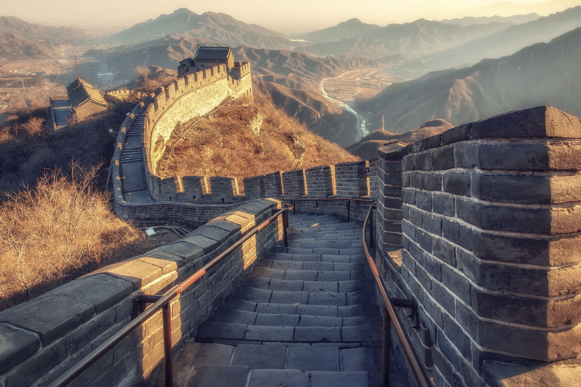 Travellers watching sunrise from the Great Wall ramparts