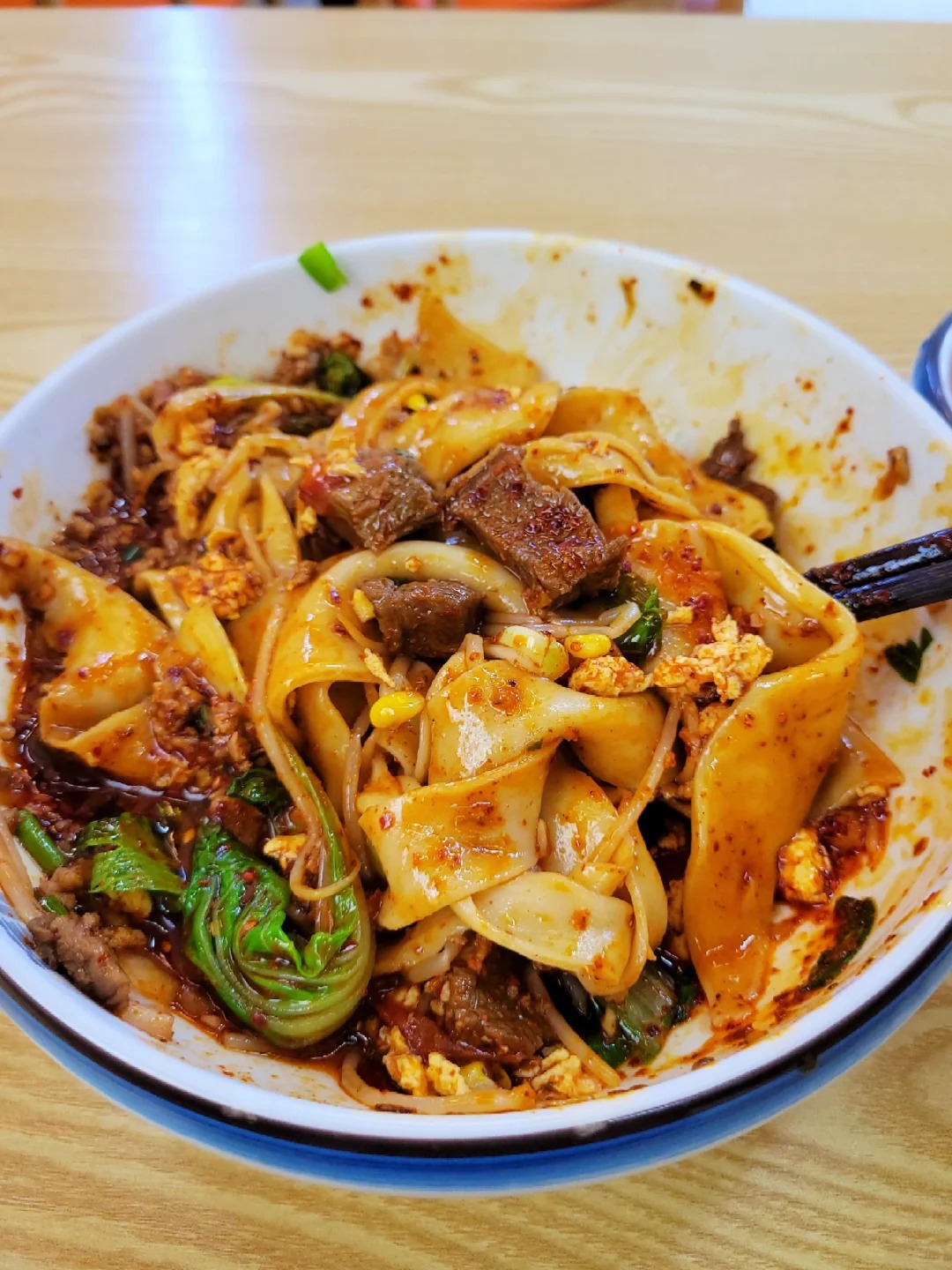 Bowl of biang biang noodles with chili sauce